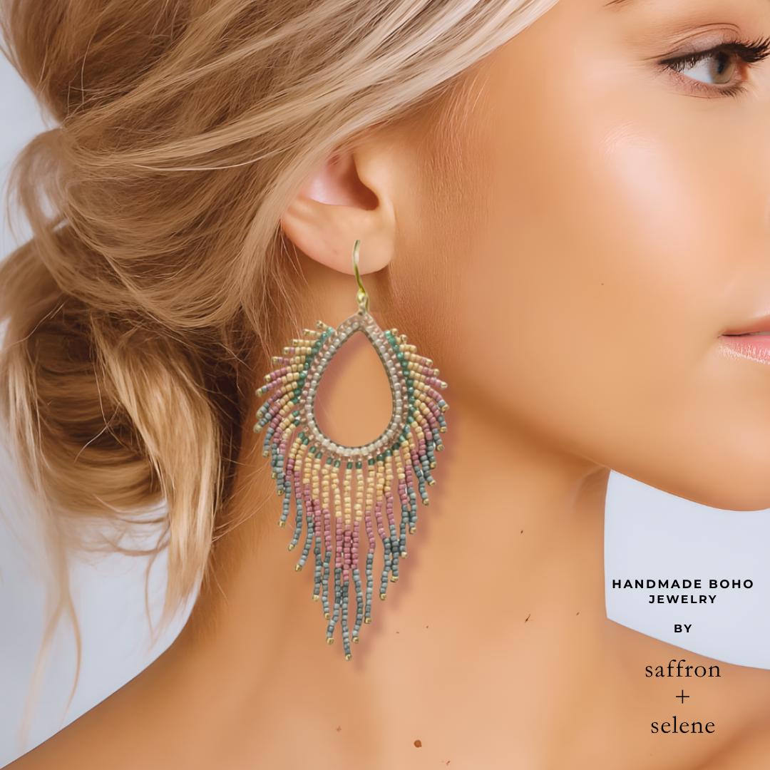 Blush pink drop earrings worn on model showing size