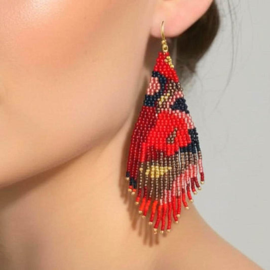 Red, black, and gold fringe beaded earrings with a floral design. . The earrings are hanging from a 9kt gold plated hook.  Handmade by Saffron and Selene Boho Jewelry