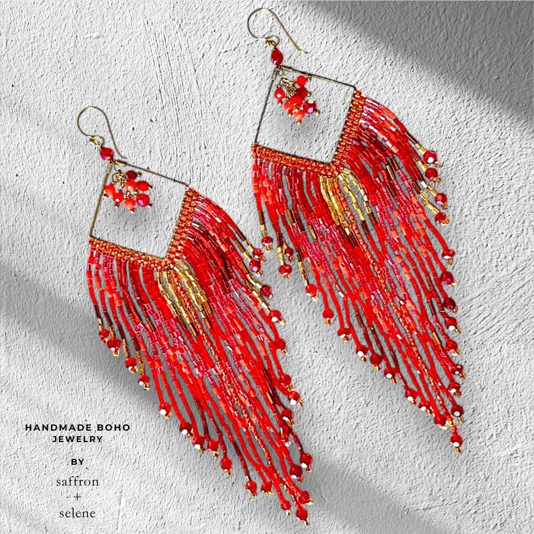 Long boho fringe earrings flat lay on neutral background, seed bead drop style, handmade