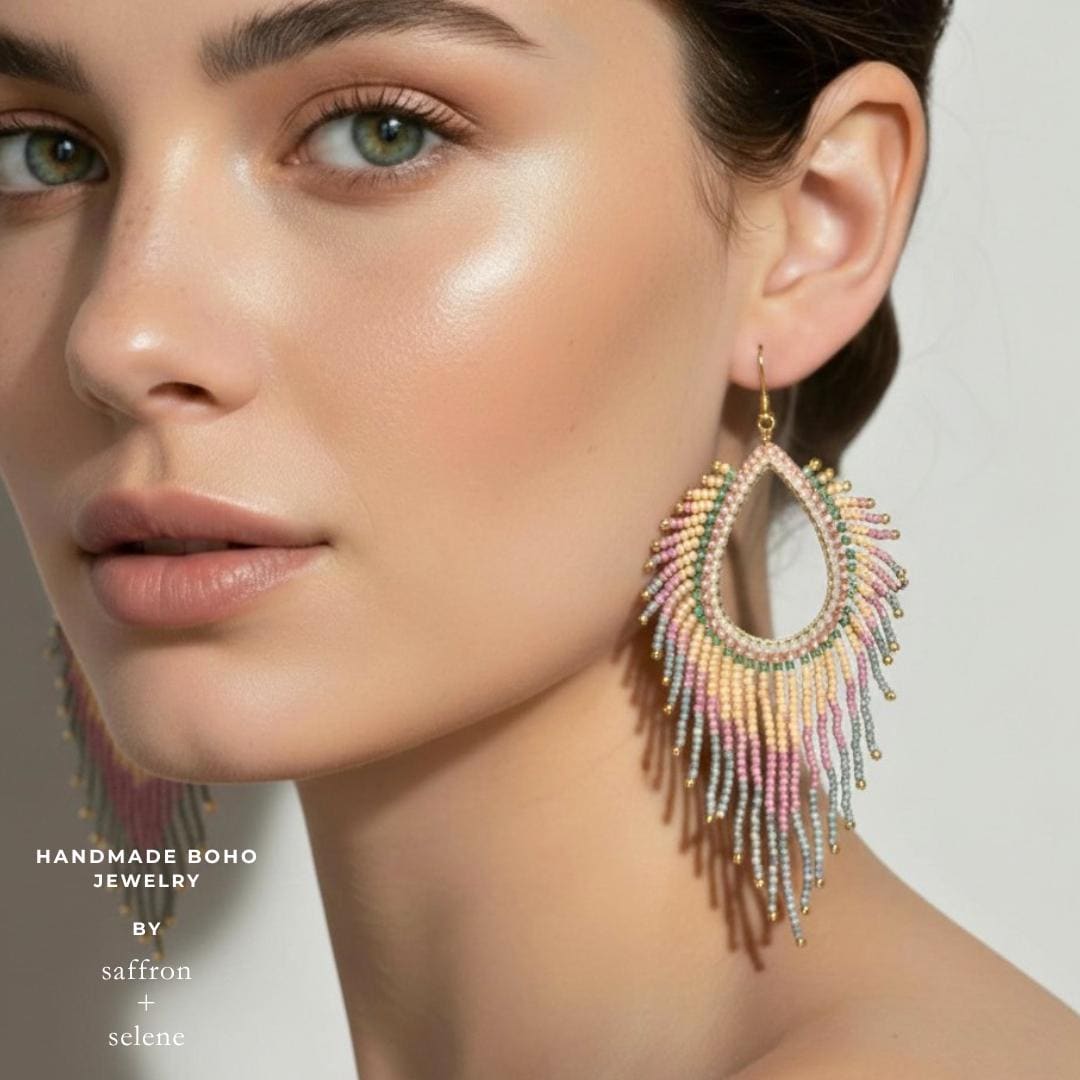 Model wearing pastel beaded fringe earrings showing detail and jade tassle.  Statement boho style, perfect for boho weddings, summer parties and festivals. Handmade by Meg at Saffron and Selene