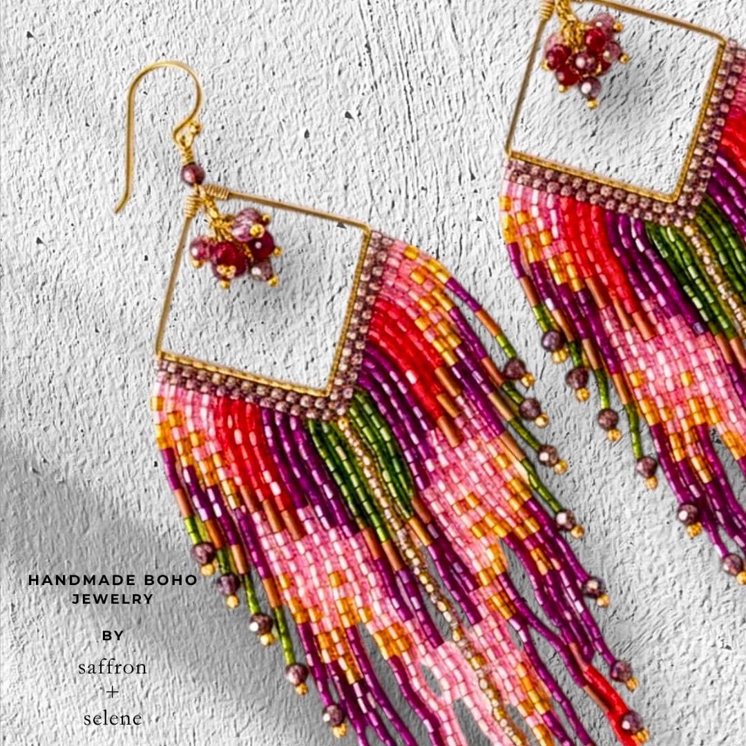 Long pink and purple beaded earrings with flowing fringe and artisan beadwork