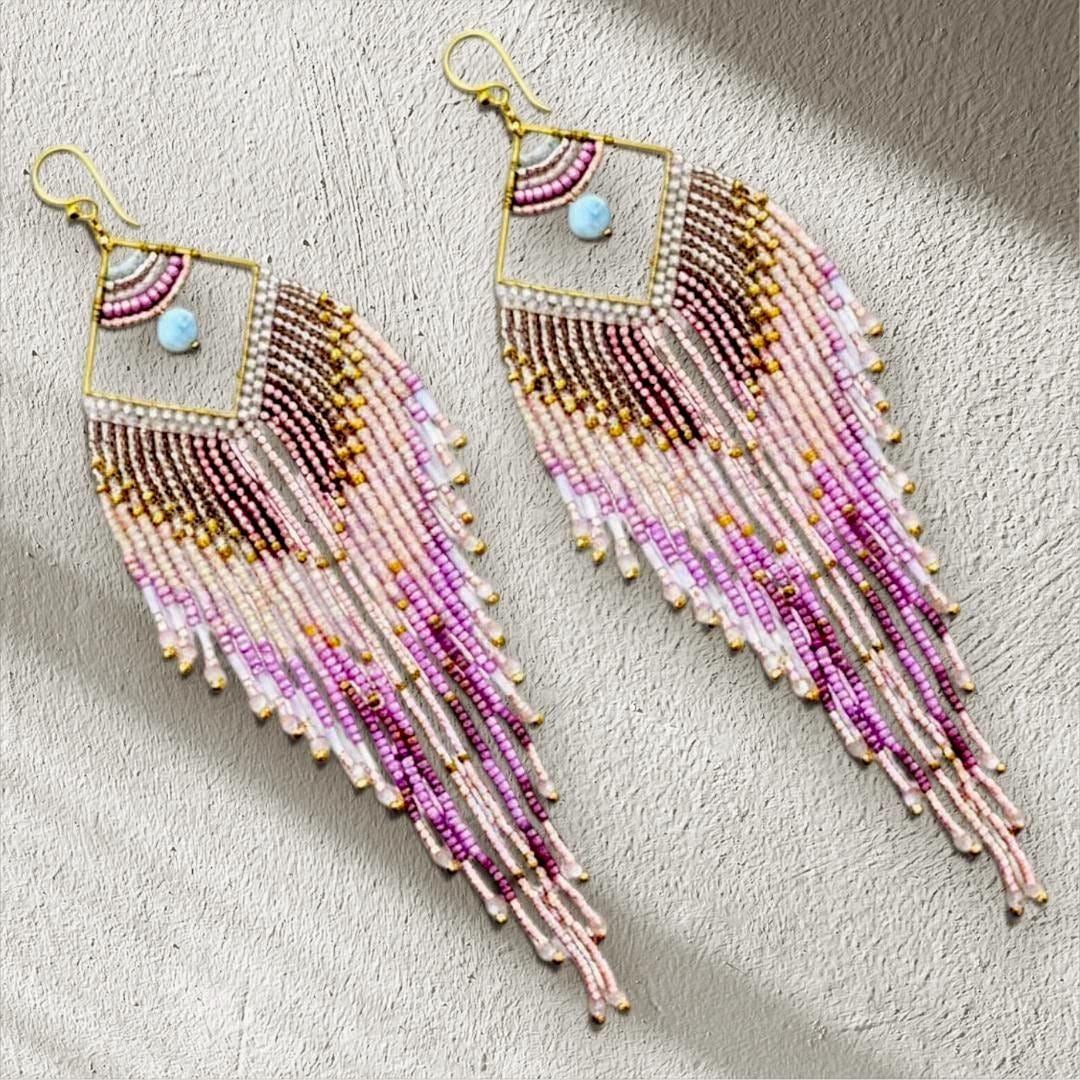 Pink beaded fringe earrings styled for festival fashion and vacation outfits