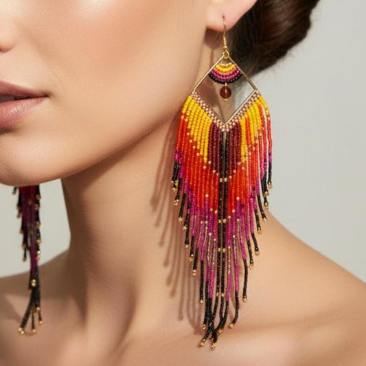 Model wearing colorful statement earrings with yellow orange pink and purple fringe