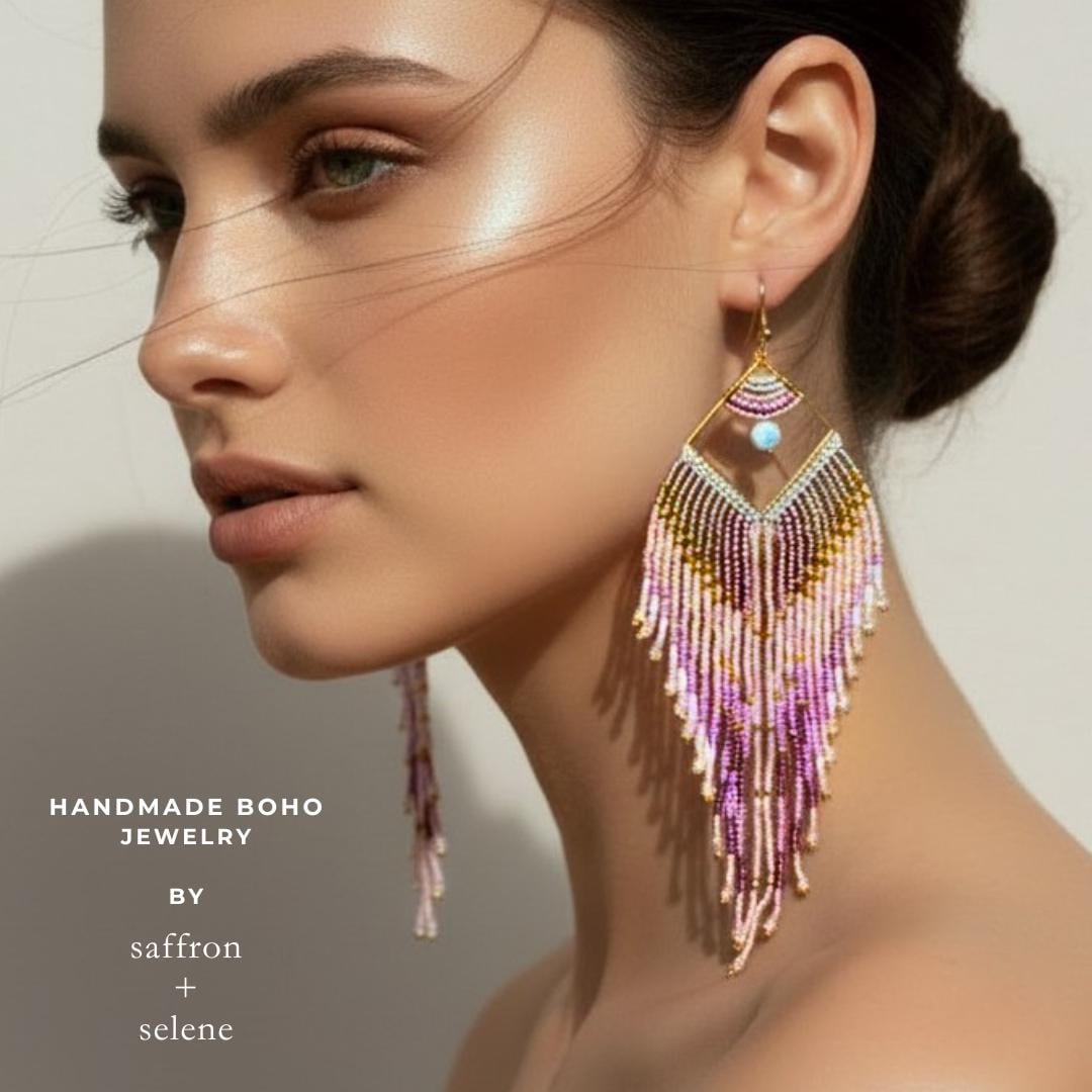 Long handmade earrings with blush pink seed beads shown worn on model