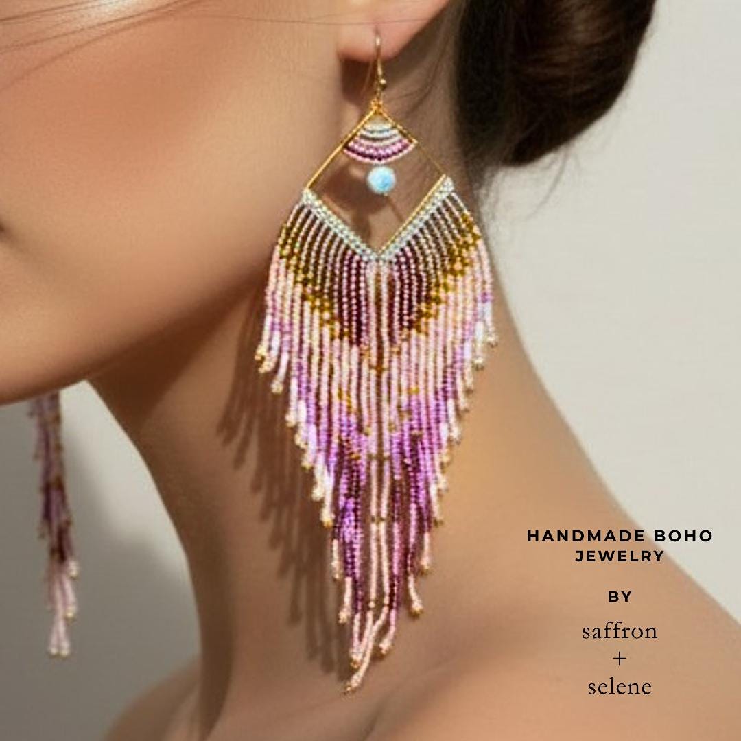 Long handmade earrings with blush pink seed beads shown worn on model