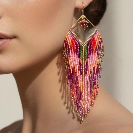 Pink fringe earrings worn by model featuring handcrafted seed bead fringe and boho statement style