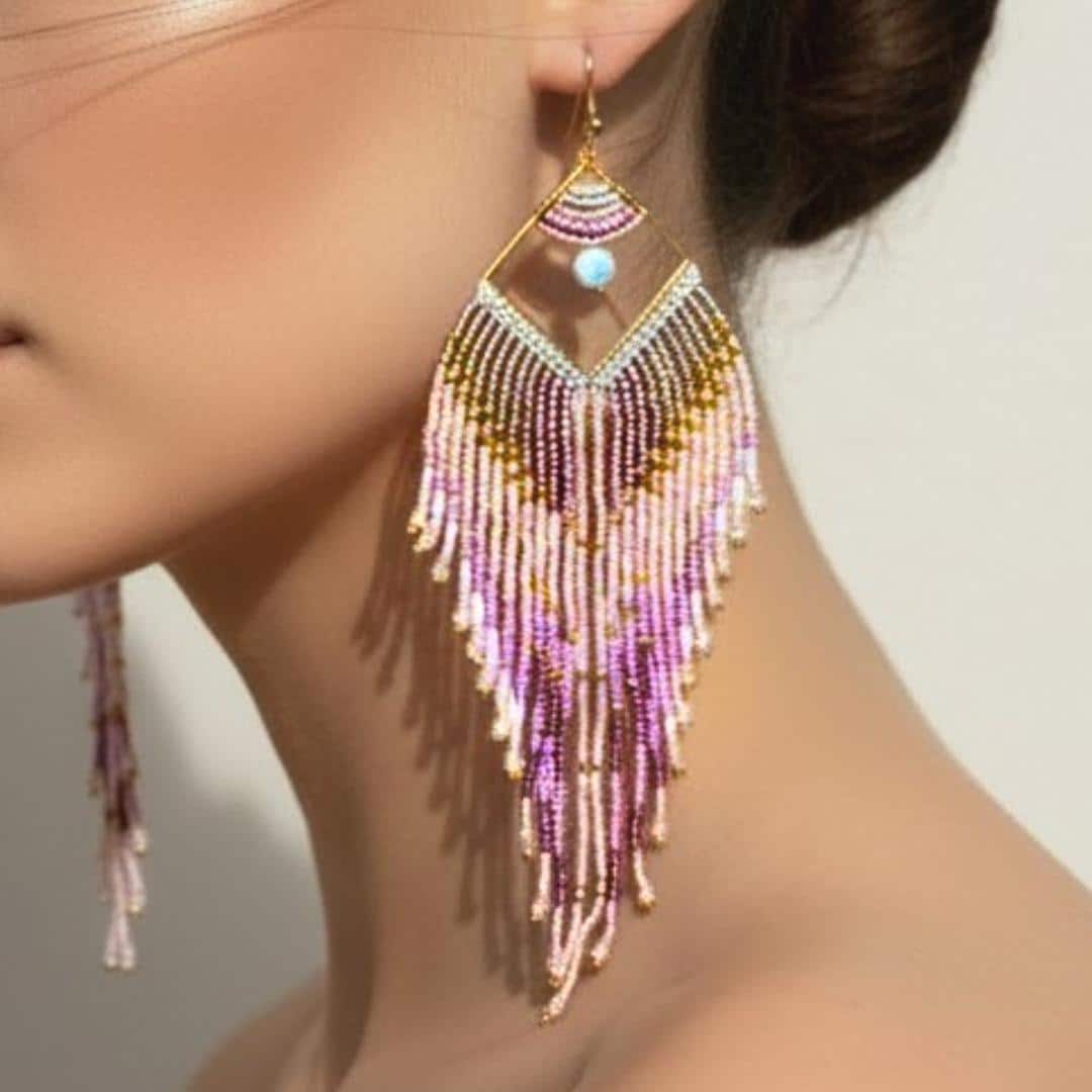 Model wearing pink fringe earrings with handmade seed bead fringe and gold frame