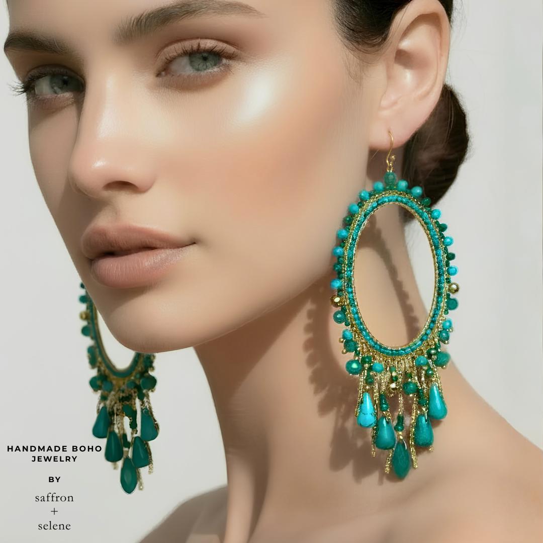 Handmade turquoise dangling earrings.  Chandelier design set on an 9kt gold plated oval frame with gold chain and jade bead detail.    Handbeaded by Saffron and Selene Boho Jewelry.  Perfect for festivals, cowgirl glam, summer holidays and parties.