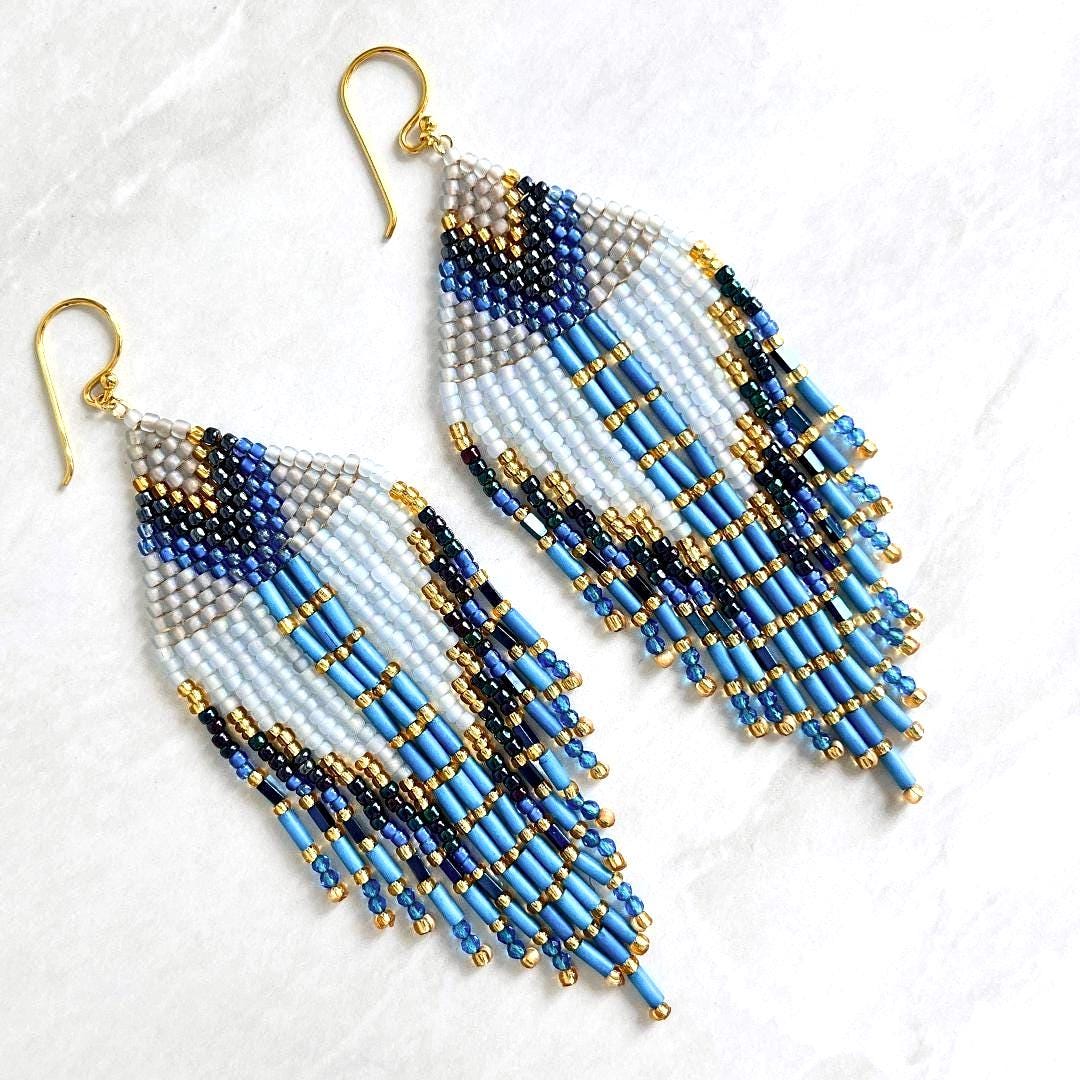 Handmade blue fringe earrings with white seed beads and gold accents