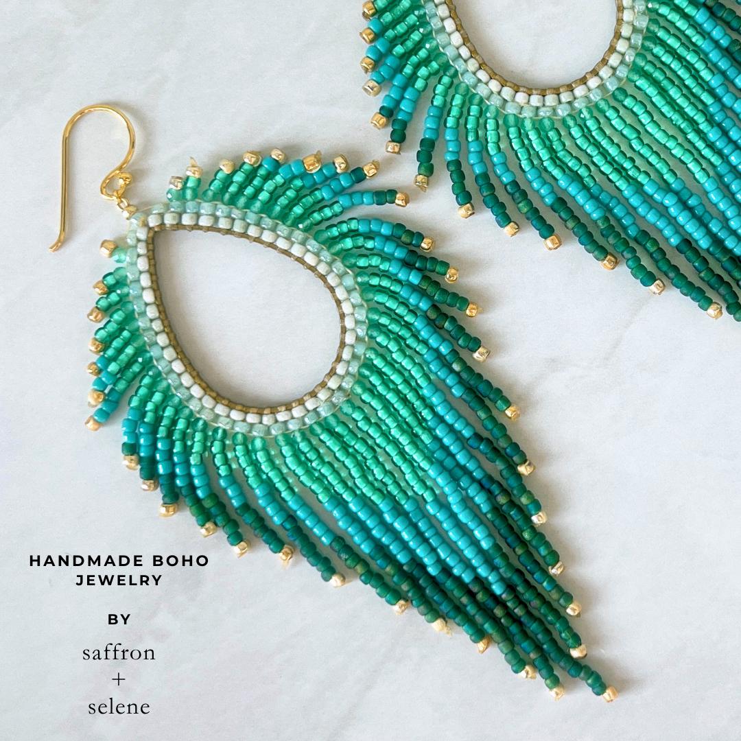 Boho statement fringe earrings handcrafted with turquoise and emerald glass beads.