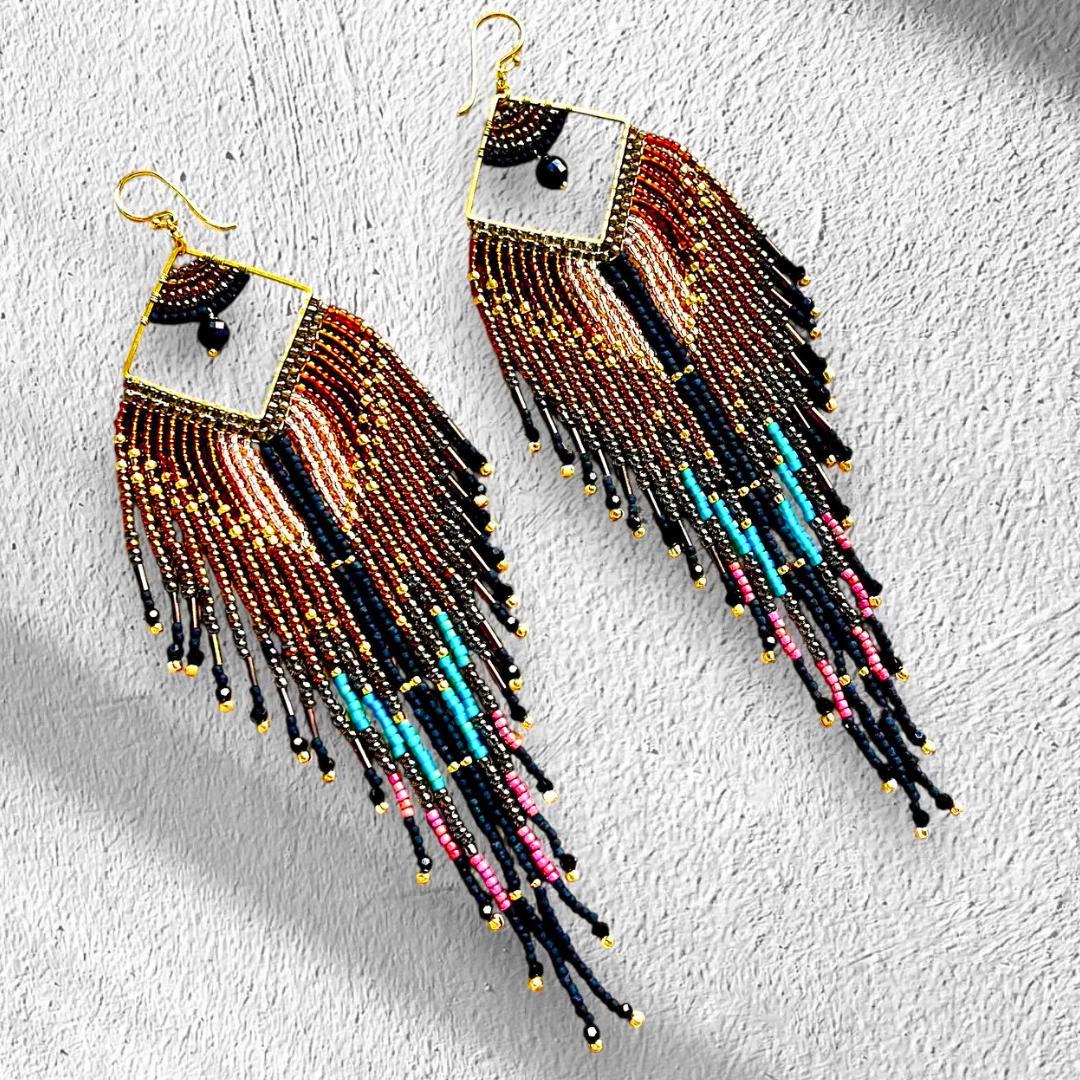 Feather design long fringe earrings in bronze and black with turquoise highlights.  Hand beaded with Japanese seed beads on a 9kt gold plated frame.  These cowgirl glam earrings are great for festivals and parties.  Handmade by Saffron and Selene Boho Jewelry