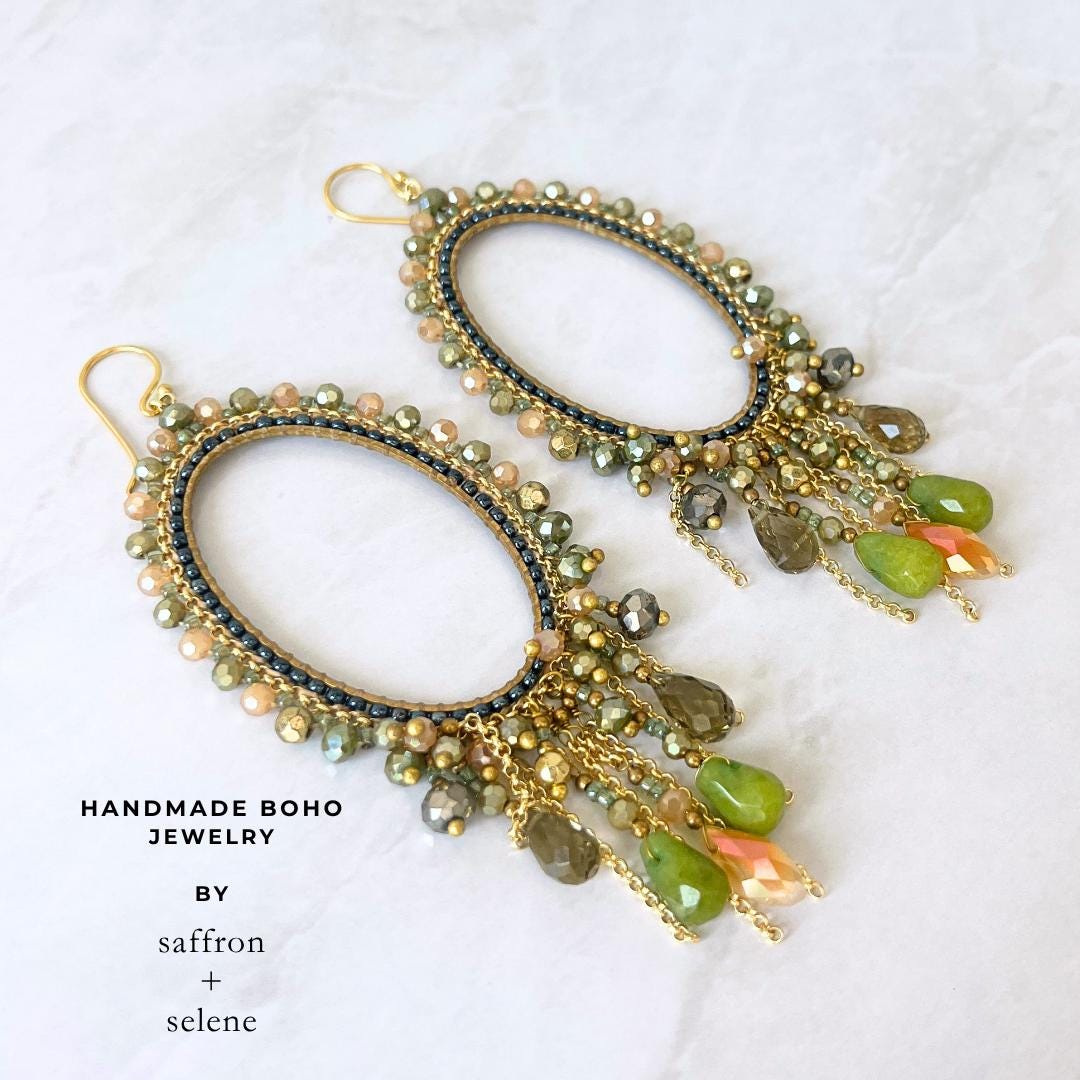 Handmade olive green beaded earrings with faceted glass crystal teardrops.