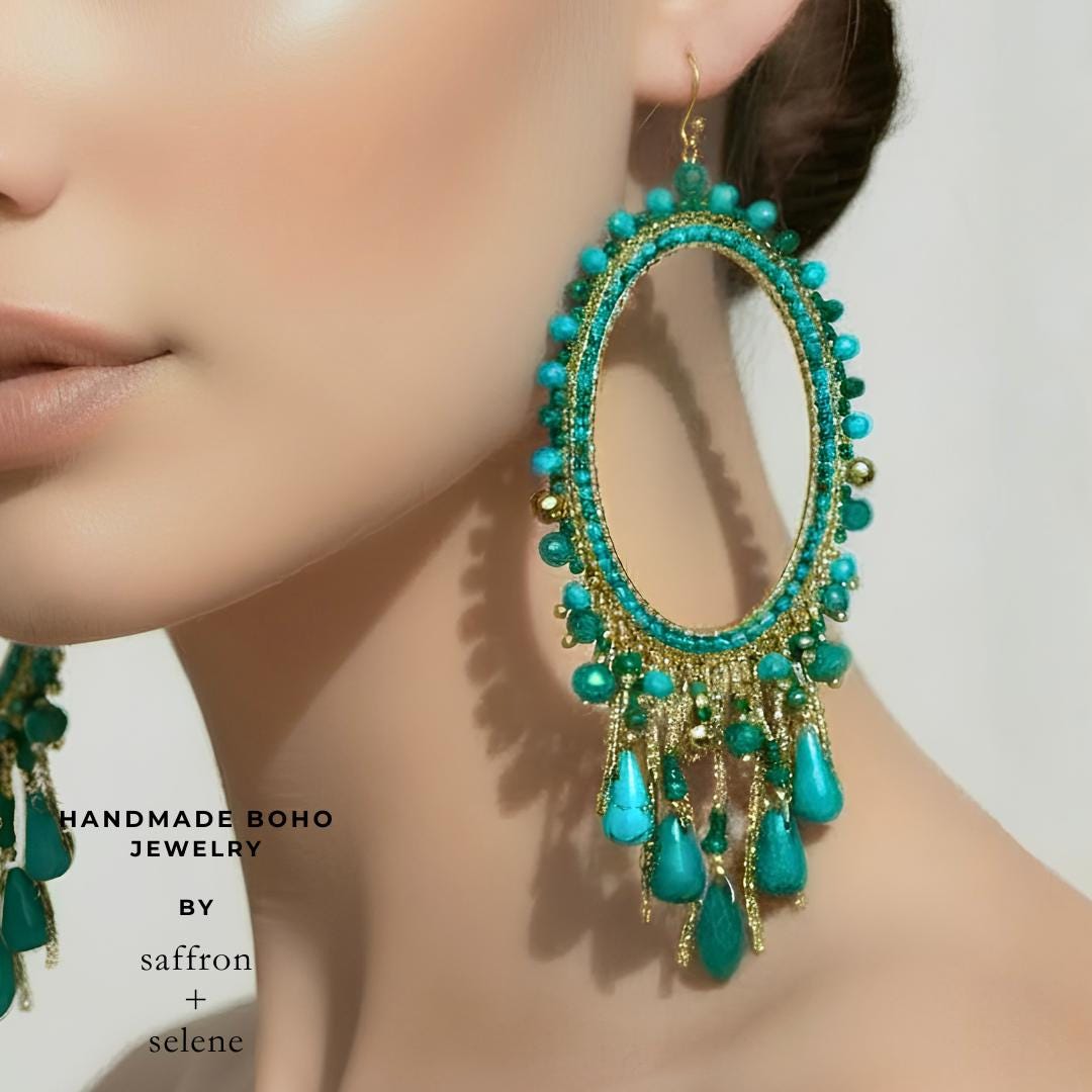 Model wearing turquoise and Jade handmade chandelier earrings with 9kt gold plated oval frame.  Hand beaded by Meg at Saffron and Selene