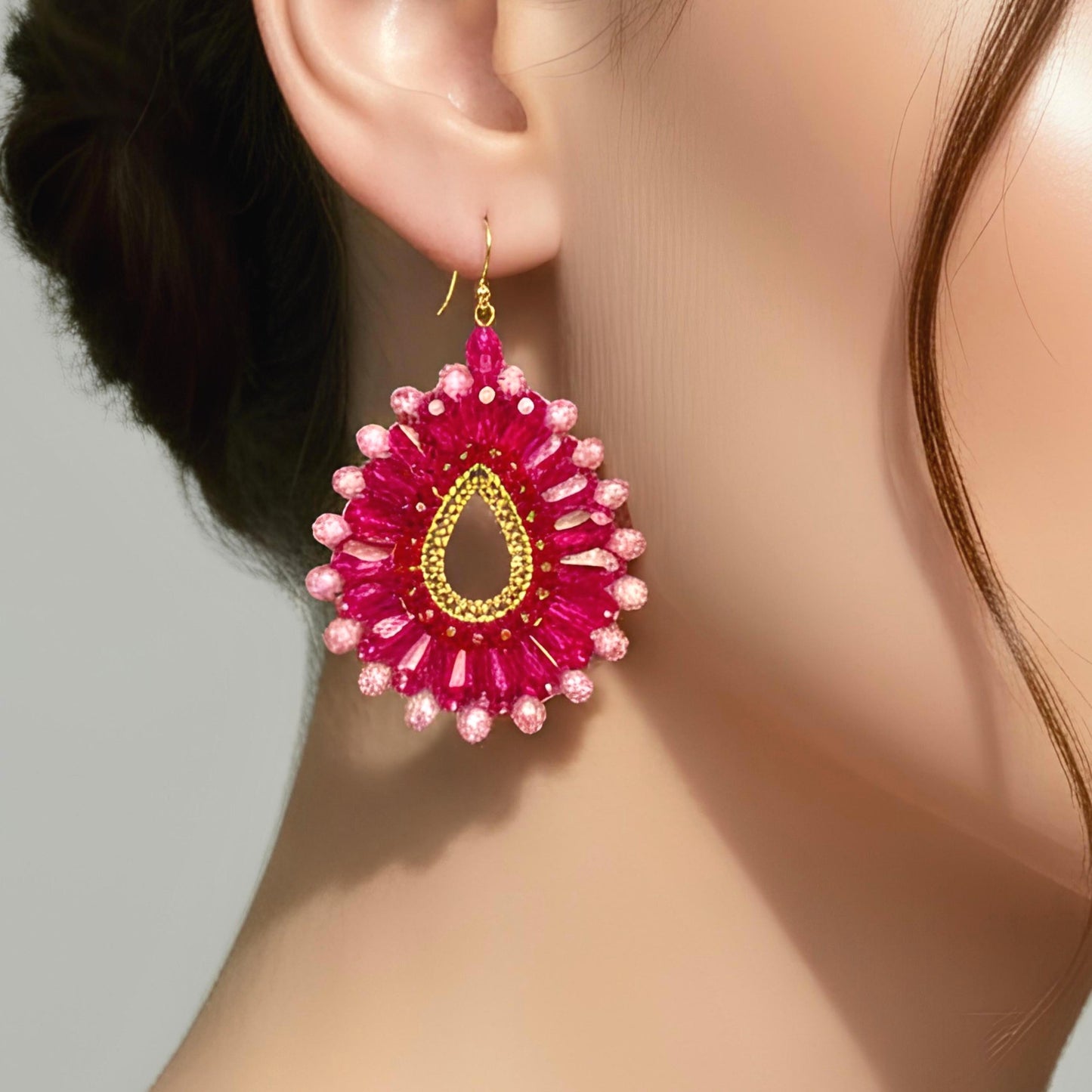 Pink statement earrings featuring faceted crystal beads and gold plated ear hooks.