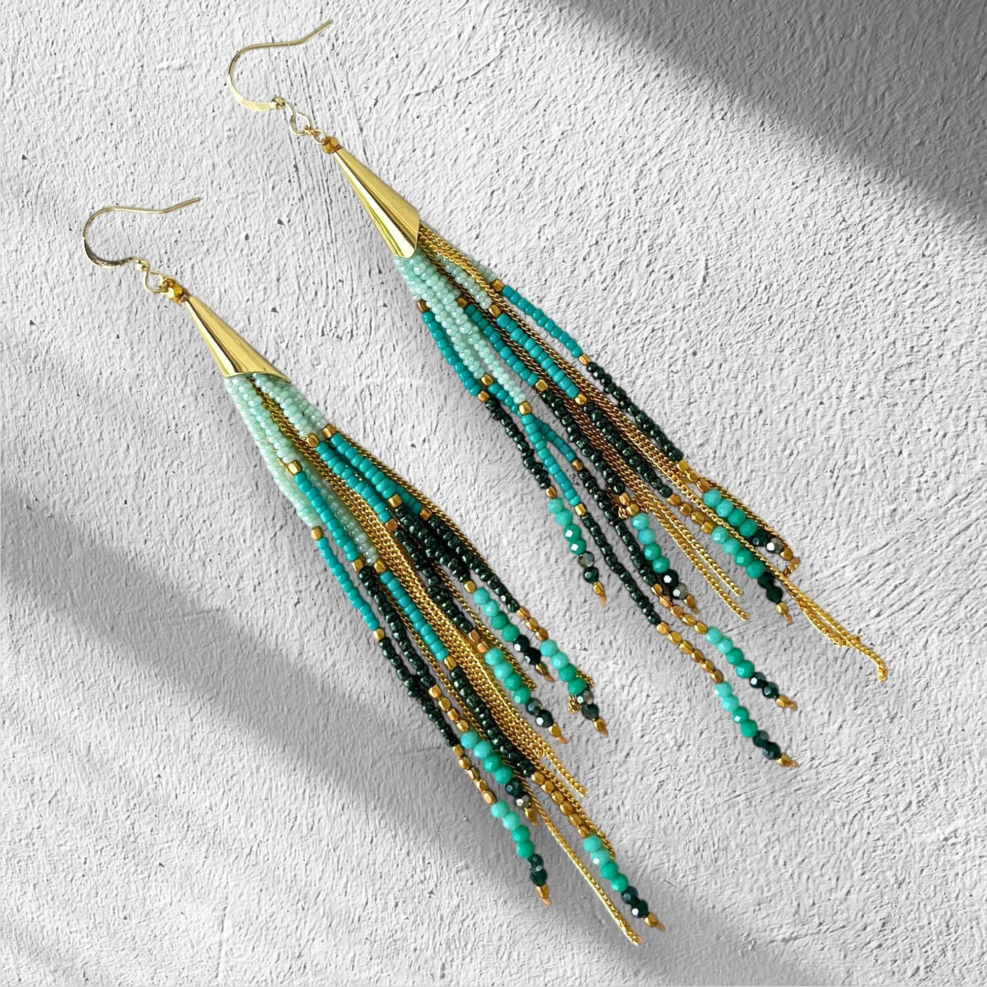Handmade turquoise fringe earrings with Miyuki seed beads, jade green crystals, gold chain tassels and long boho statement design.