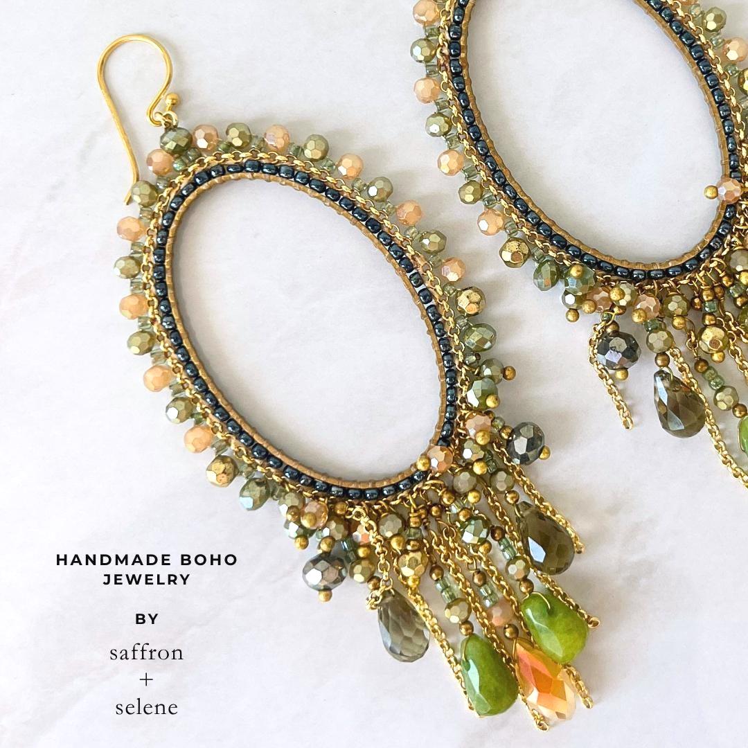 Handmade olive green chandelier earrings with faceted crystal drops and gold oval frame.