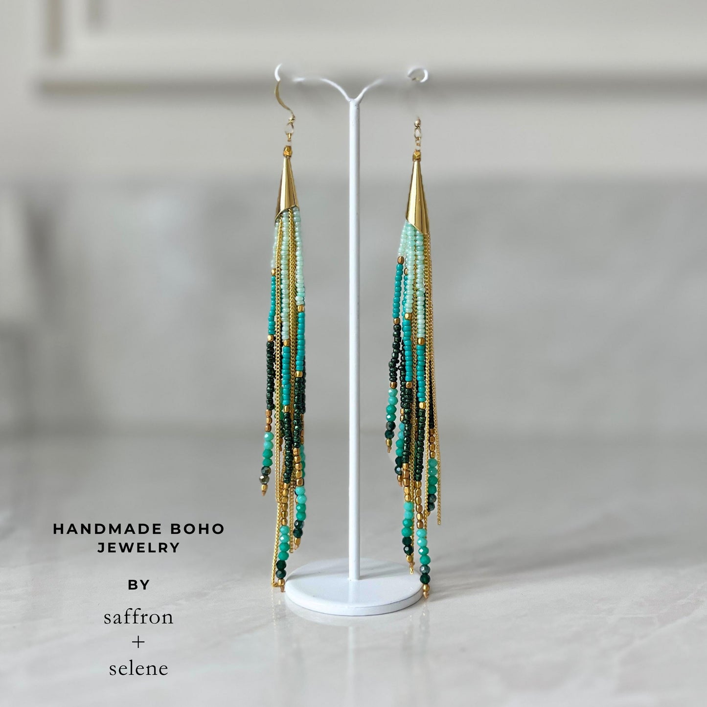 Statement turquoise dangle earrings featuring layered bead fringe, fine gold chains and handcrafted bohemian styling.