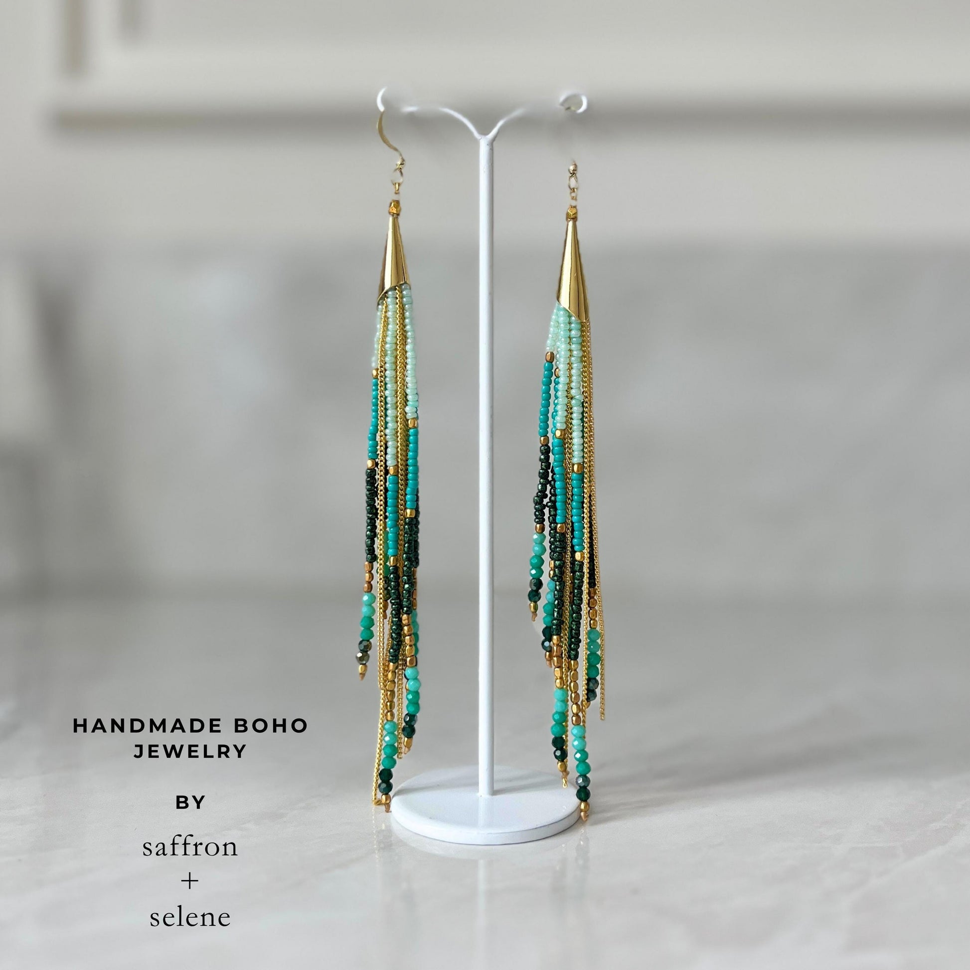 Statement turquoise dangle earrings featuring layered bead fringe, fine gold chains and handcrafted bohemian styling.