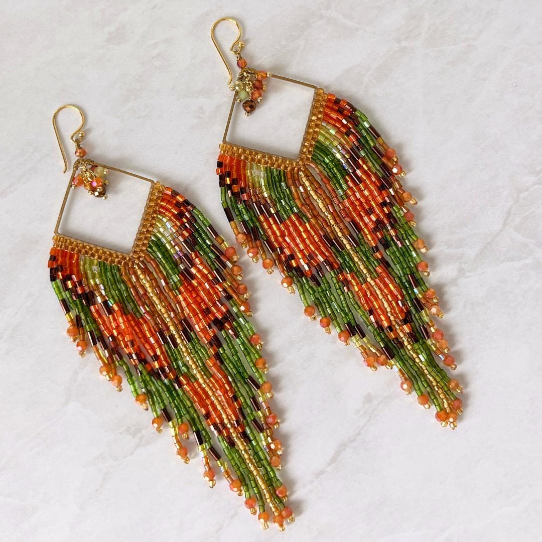 Handcrafted festival fringe earrings in burnt orange, chartreuse and bronze with elegant bohemian styling.